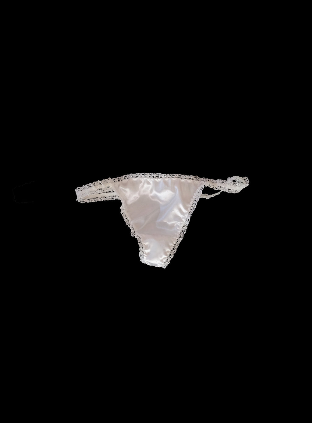Luxury off-white silky satin t-bar thong with delicate lace elastic trim, low-rise design, smooth fabric texture, handcrafted in London premium lingerie